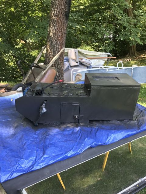 1989 Ford Bronco - A black center console, possibly from a vehicle, is displayed outdoors on a blue tarp.