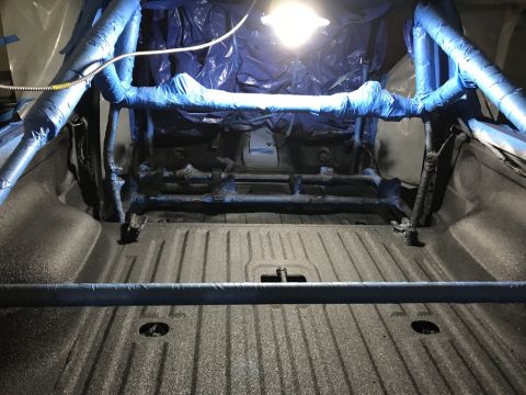1989 Ford Bronco - Interior view of a truck bed being prepped for a roll cage installation.