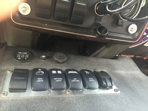 1989 Ford Bronco - Custom interior switches control various lighting options, including rear lights, off-road lights, LED light bar, and rock lights.