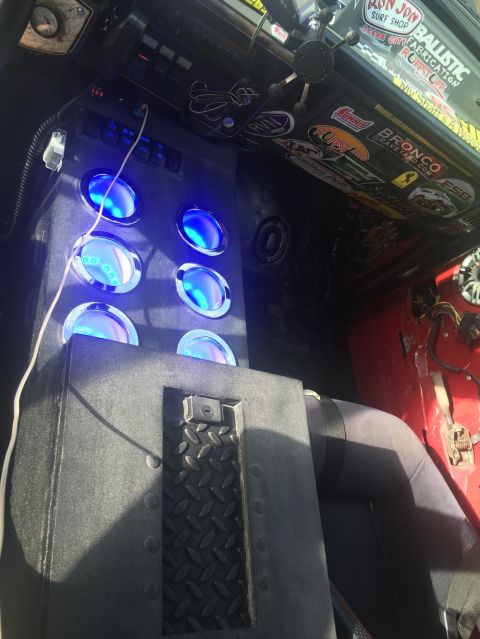 1989 Ford Bronco - Interior view of a vehicle's custom center console multiple gauges with blue lighting.