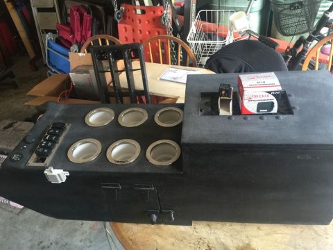 1989 Ford Bronco - Custom center console unit with cup holders and switches, likely for an older vehicle modification.