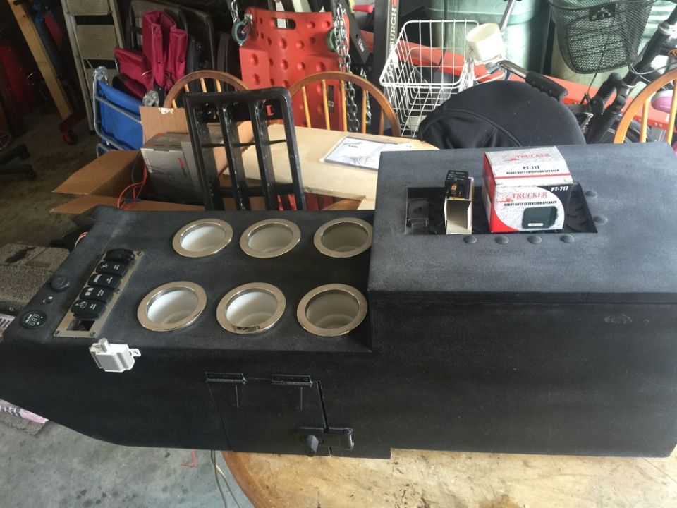 Custom center console unit with eight cup holders, multiple switches, and a box for a Tracker PT-111 device