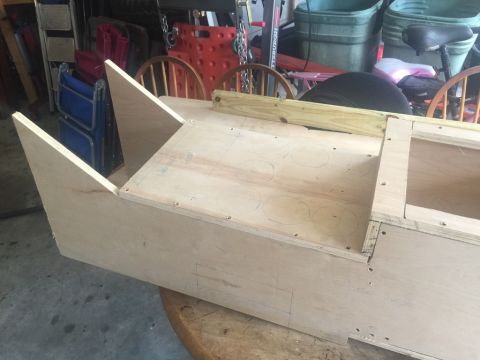 1989 Ford Bronco - A partially constructed wooden box with angled front sections is shown, possibly a custom build or part.