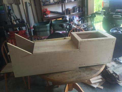 1989 Ford Bronco - A wooden center console is being built on a table in a garage.