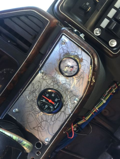 1989 Ford Bronco - Aftermarket gauges are installed on the dashboard, with exposed wiring visible.