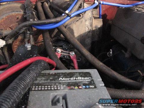1989 Ford Bronco - The engine bay features a NorthStar battery and a complex network of hoses and wiring.