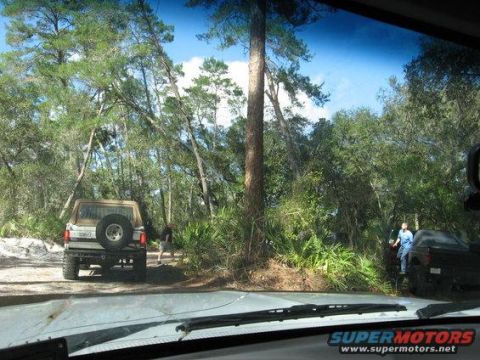1989 Ford Bronco - 1989 Ford Bronco seen off-road with another vehicle nearby.