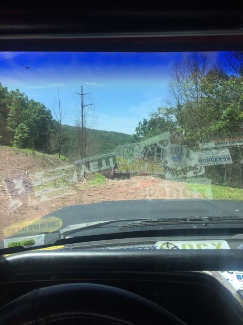 1989 Ford Bronco - Driving on a dirt path through a wooded area on a sunny day.