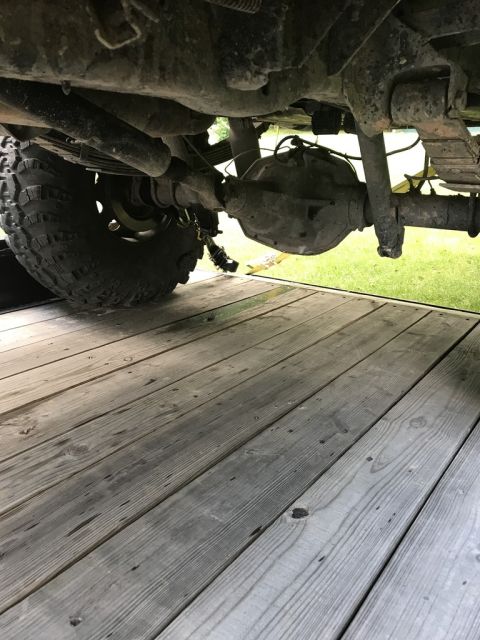 1989 Ford Bronco - A close-up view of the rear axle and suspension components of a vehicle.