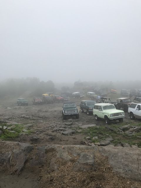 1989 Ford Bronco - Multiple off-road vehicles are gathered in a foggy outdoor environment.