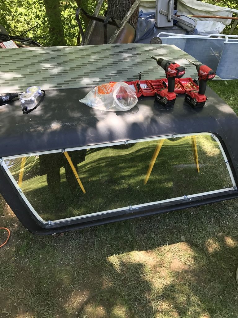 Black hard top with window frame and tools on top