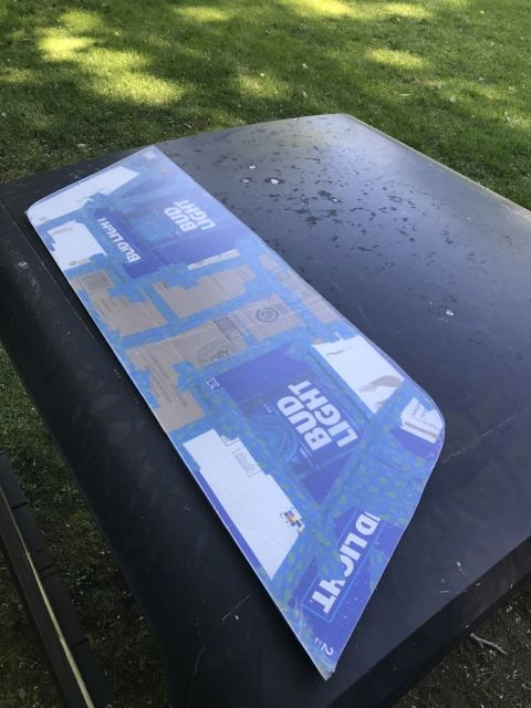 1989 Ford Bronco - A template made from Bud Light boxes is taped onto the hood of a vehicle.