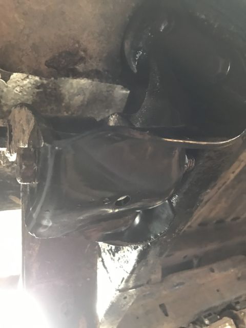 1989 Ford Bronco - Leaf spring shackle bracket, possibly from a 1989 Ford Bronco, showing some wear and tear.