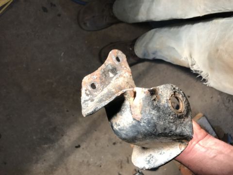 1989 Ford Bronco - Close-up of a rusted metal bracket, likely a vehicle part, with the Supermotors.net logo in the corner.