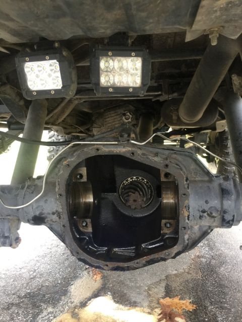 1989 Ford Bronco - The differential housing is open, revealing internal gears, with two auxiliary LED lights mounted overhead.