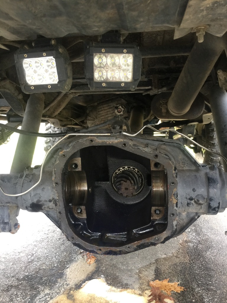 Underside of a vehicle showing an open differential housing with two LED light bars mounted above