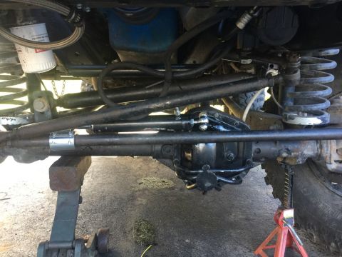 1989 Ford Bronco - Underneath view of the front axle and steering system of a 1989 Ford Bronco.
