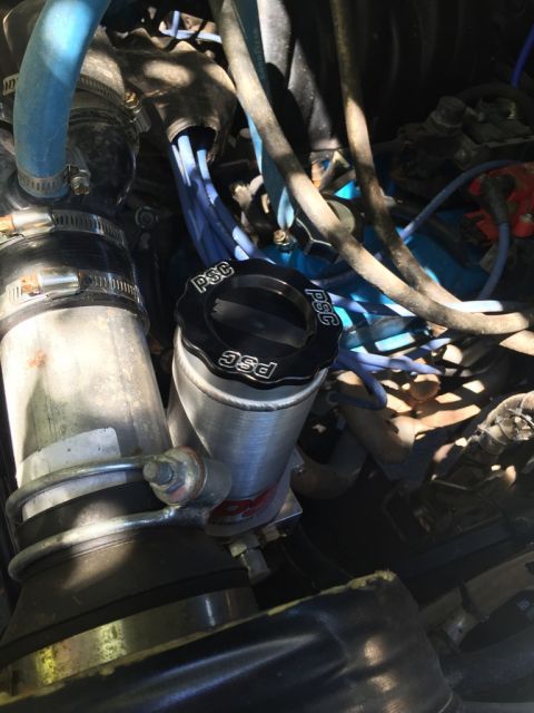 1989 Ford Bronco - Close-up view of an engine bay, focusing on a PSC reservoir and associated engine components.