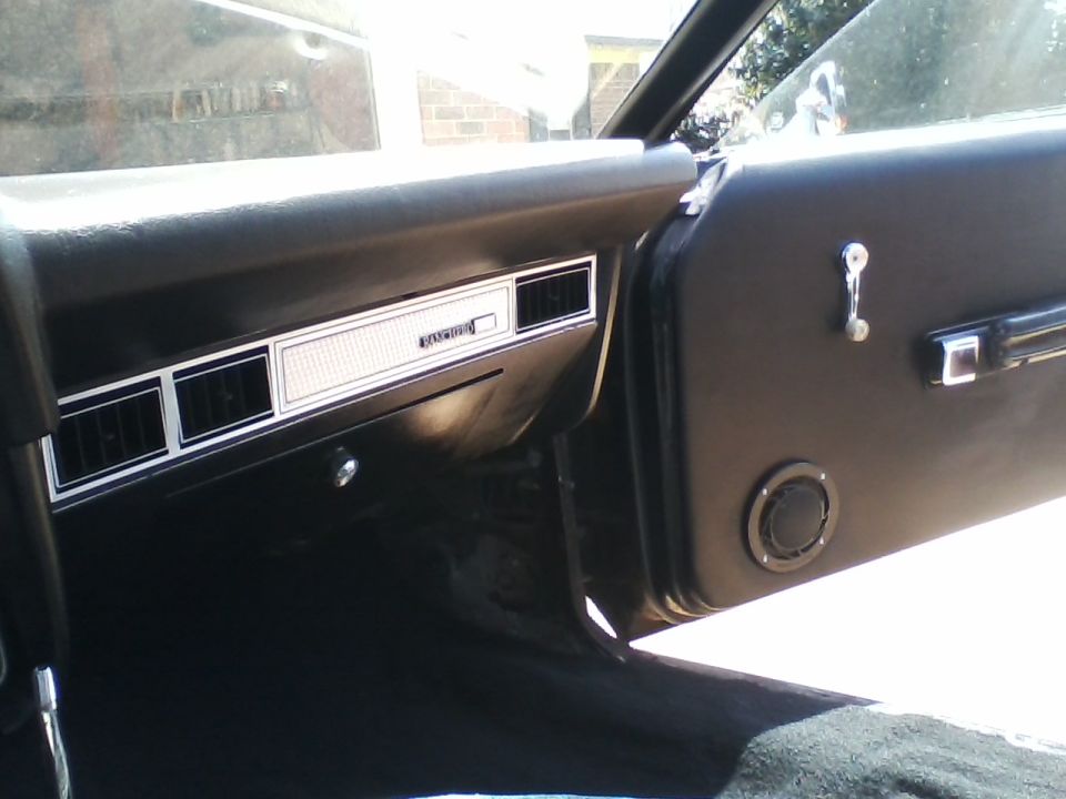 Interior of a 1978 Ford Ranchero showing dashboard vents and door panel speaker.