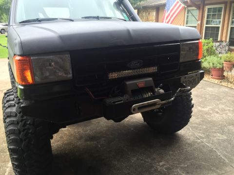 1989 Ford Bronco - Front view of a black Ford Bronco with a custom bumper, winch, and LED light bar. The vehicle has large off-road tires and a Maryland licen…