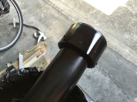 1989 Ford Bronco - A black snorkel pipe is shown on a concrete surface with wood scraps and a bicycle wheel nearby.