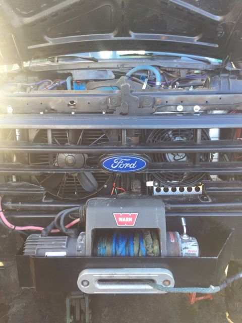 1989 Ford Bronco - Front view of a 1989 Ford Bronco's engine bay, showing the grille, winch, and engine components.