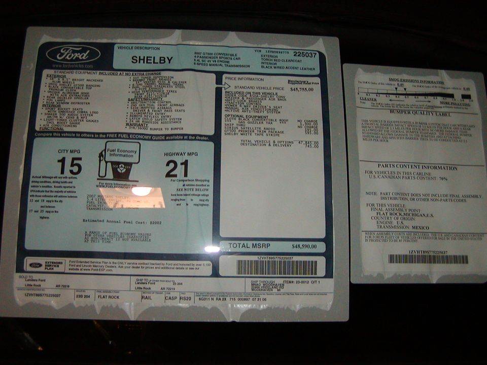 Shelby Monroney window sticker beside emissions and parts content addendum label