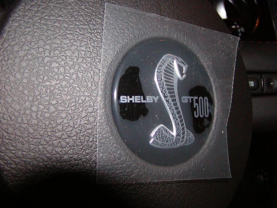 Shelby GT500 emblem on a steering wheel with protective film