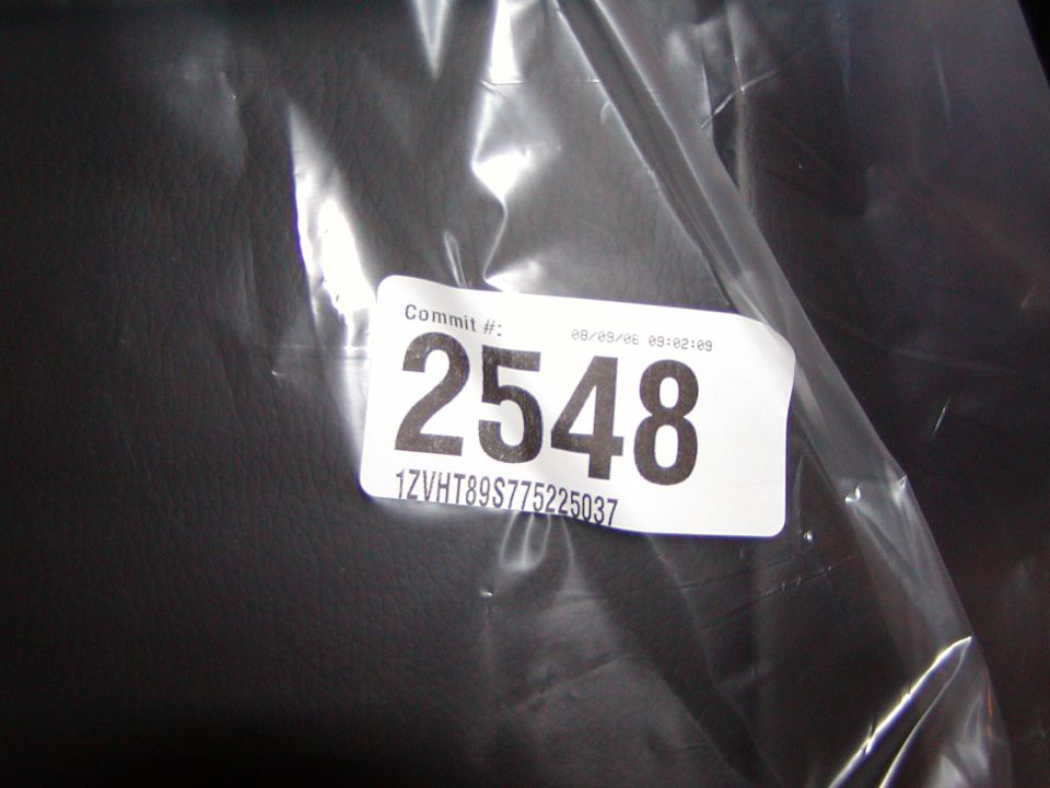 White label with black text: Commit #: 2548, 1ZVHT89S775225037, and date/time 08/09/06 09:02:09