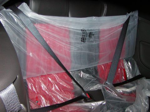 2007 Ford Mustang - The interior of a car shows the rear seats covered in protective plastic sheeting.