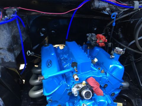 1989 Ford Bronco - A close-up, high-angle view of a bright blue Ford V8 engine, likely from a 1989 Ford Bronco, with various hoses and components visible. The…