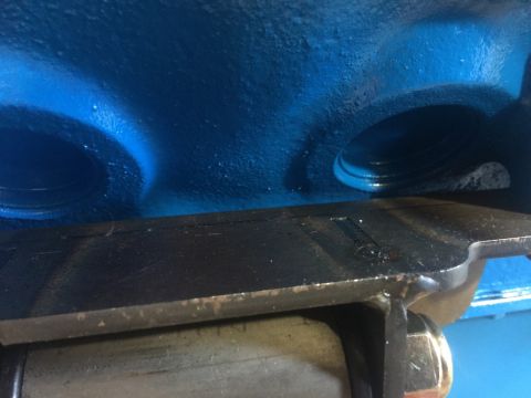 1989 Ford Bronco - This is a close-up view of the intake ports of a blue engine, possibly a Ford Bronco, with a black metal plate in the foreground. The plate…