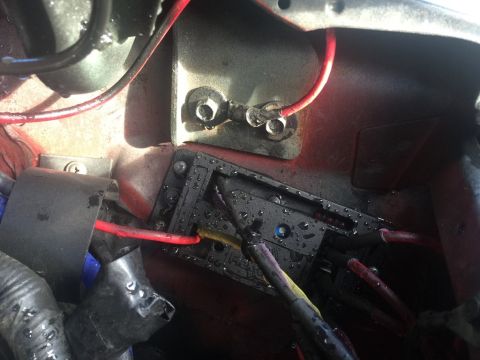 1989 Ford Bronco - A close-up view shows a black plastic electrical component with multiple red and black wires connected to it. The component is mounted to a…
