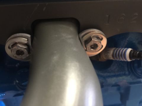 1989 Ford Bronco - A close-up view of engine components, including a spark plug and mounting hardware.