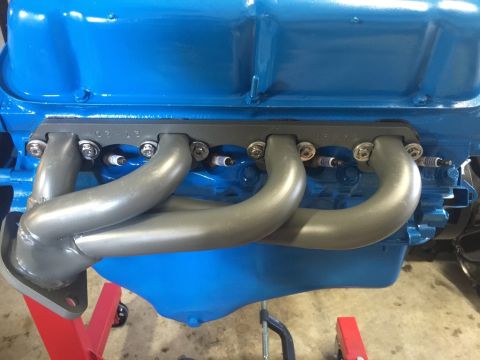1989 Ford Bronco - Close-up of an engine's exhaust headers and spark plugs, with a SuperMotors.net watermark.