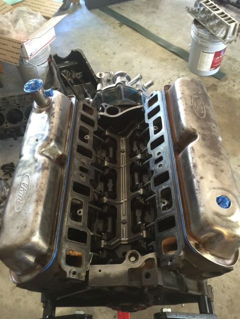 1989 Ford Bronco - Ford V8 engine block with chrome valve covers and intake manifold removed, on an engine stand.