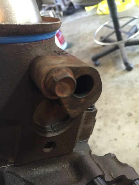 1989 Ford Bronco - Close-up view of a rusty engine component, possibly from a 1993 Mustang 302 engine swap.