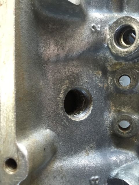 1989 Ford Bronco - This is a close-up view of a cast iron engine block, showing machined surfaces and casting marks.