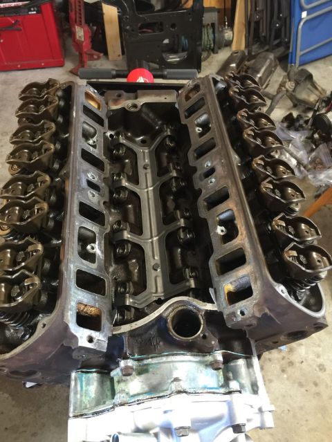 1989 Ford Bronco - Engine block and cylinder heads disassembled, revealing internal mechanical parts.