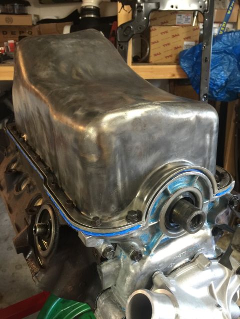 1989 Ford Bronco - Close-up view of an engine oil pan with a blue gasket installed.