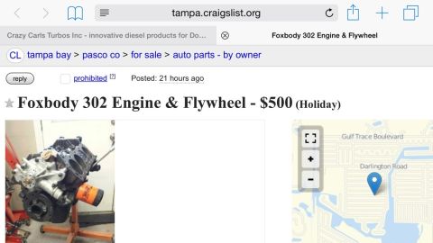 1989 Ford Bronco - Engine on stand, likely a Ford 302 V8, with an orange oil filter attached.