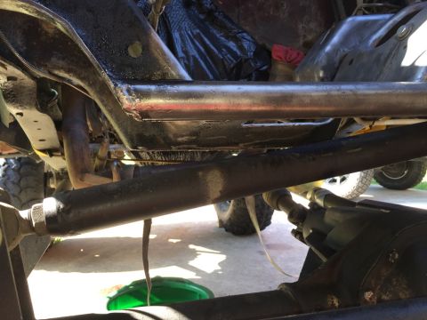 1989 Ford Bronco - Close-up view of the underside of a vehicle, showing suspension and drivetrain parts.
