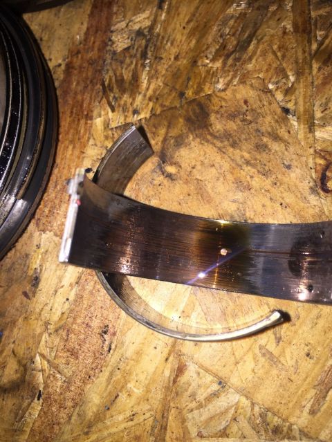 1989 Ford Bronco - A damaged engine bearing shows signs of wear and mechanical stress.