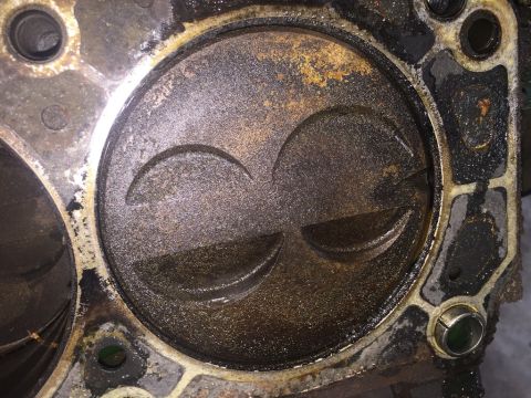 1989 Ford Bronco - Close-up of an engine cylinder and piston, showing valve reliefs.