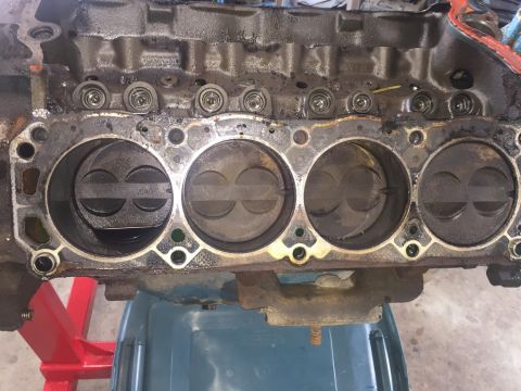 1989 Ford Bronco - The internal components of an engine block are visible, with pistons in their cylinders.