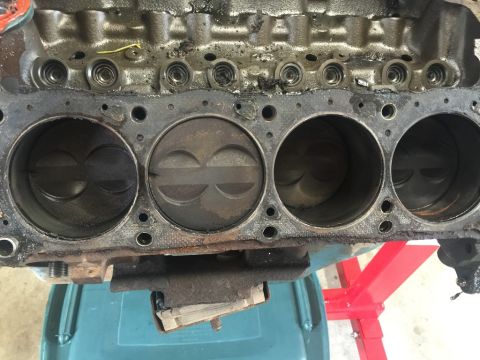 1989 Ford Bronco - Close-up view of an engine block's cylinders and pistons, indicating internal engine components.