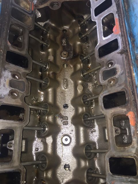 1989 Ford Bronco - Close-up of an engine cylinder head, revealing internal components and casting details.