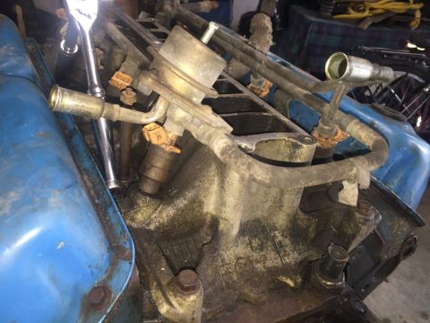 1989 Ford Bronco - Close-up of an engine's fuel system components, including injectors and a fuel pressure regulator.