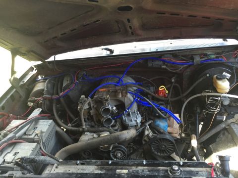 1989 Ford Bronco - Engine bay view of a V8 motor with various components and wiring clearly visible.