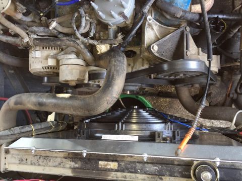 1989 Ford Bronco - The engine bay features a radiator, fan, and various engine components, including the alternator and belts.